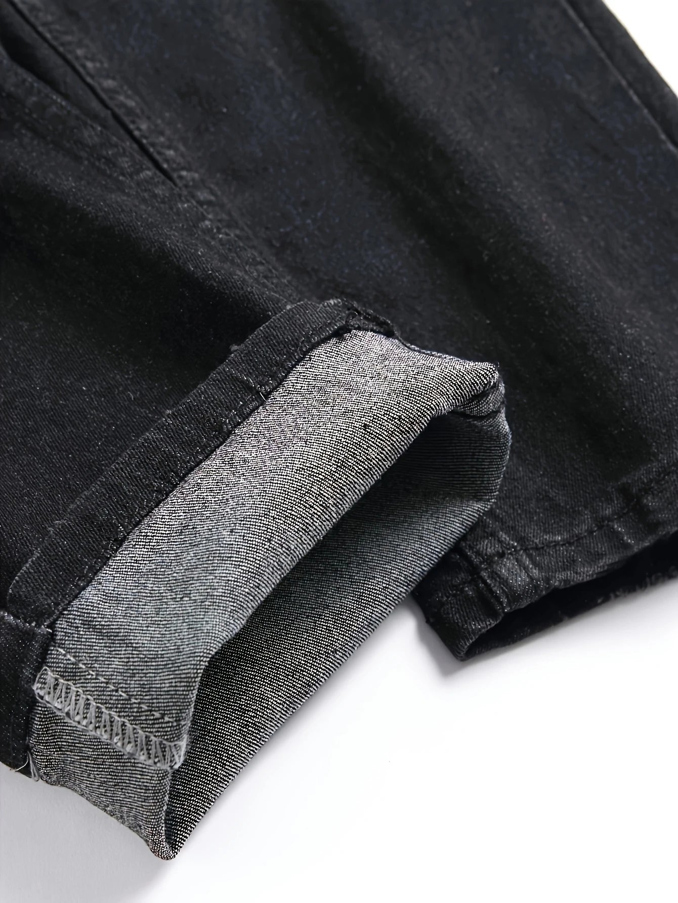 Men's black and gray distressed jeans, featuring a unique worn-out design, loose fit, and versatile style, effortlessly creating