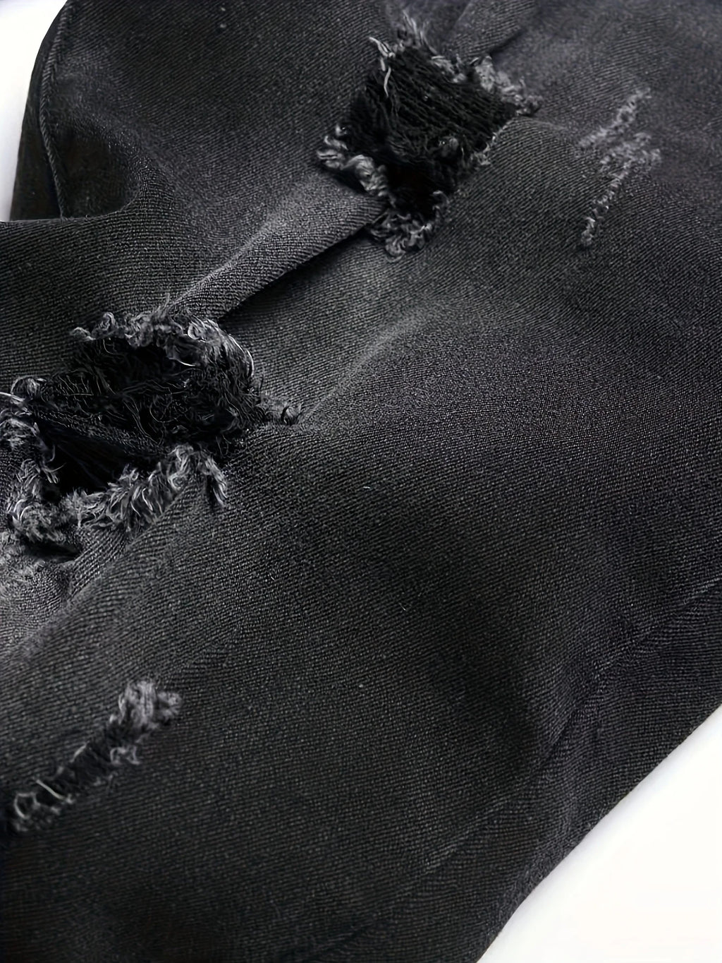 Men's black and gray distressed jeans, featuring a unique worn-out design, loose fit, and versatile style, effortlessly creating