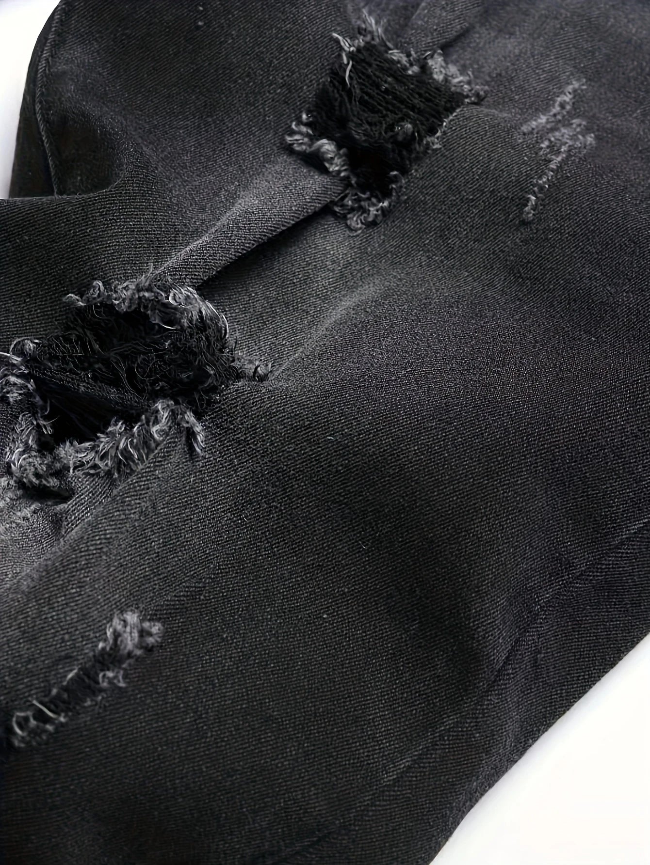 Men's black and gray distressed jeans, featuring a unique worn-out design, loose fit, and versatile style, effortlessly creating