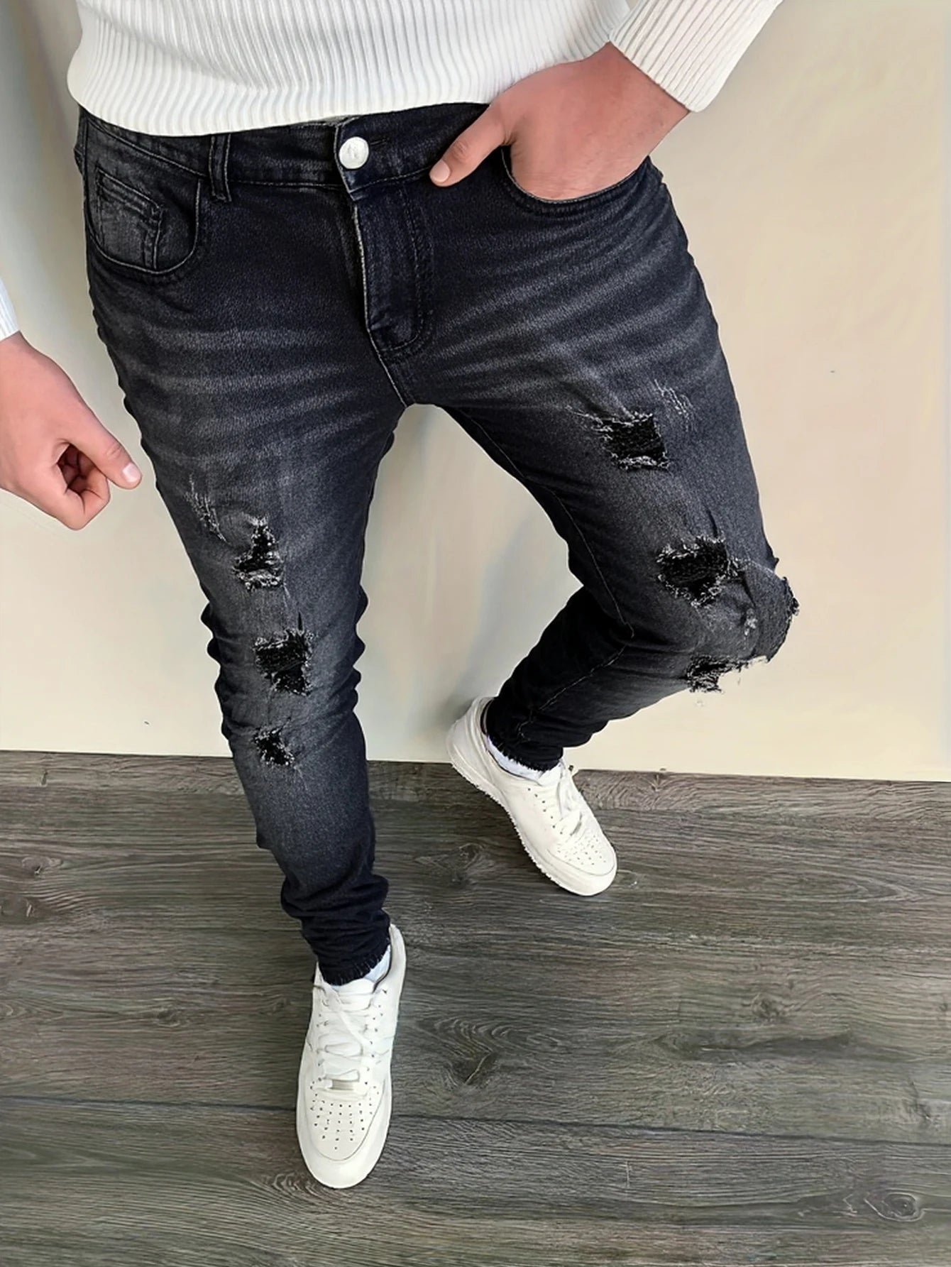 Men's black and gray distressed jeans, featuring a unique worn-out design, loose fit, and versatile style, effortlessly creating